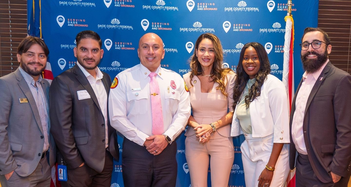 people standing in front of wall banner