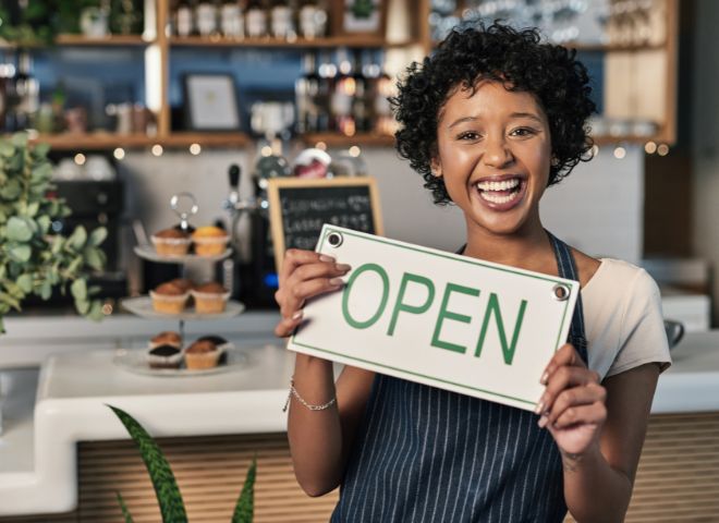 Woman holding open sign