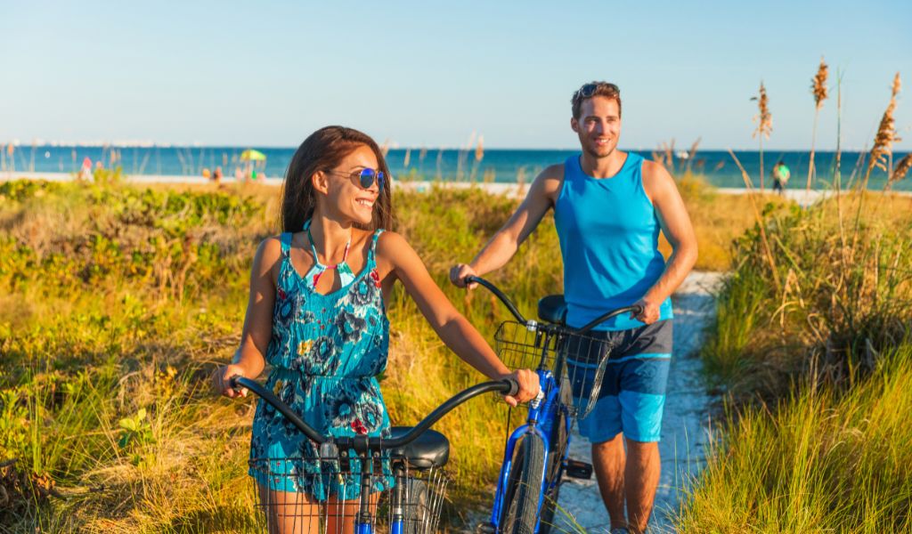 Couple with bikes on beach