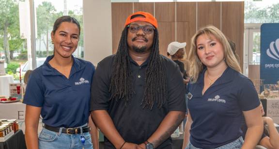 dcfcu employees with vendor at farmers market