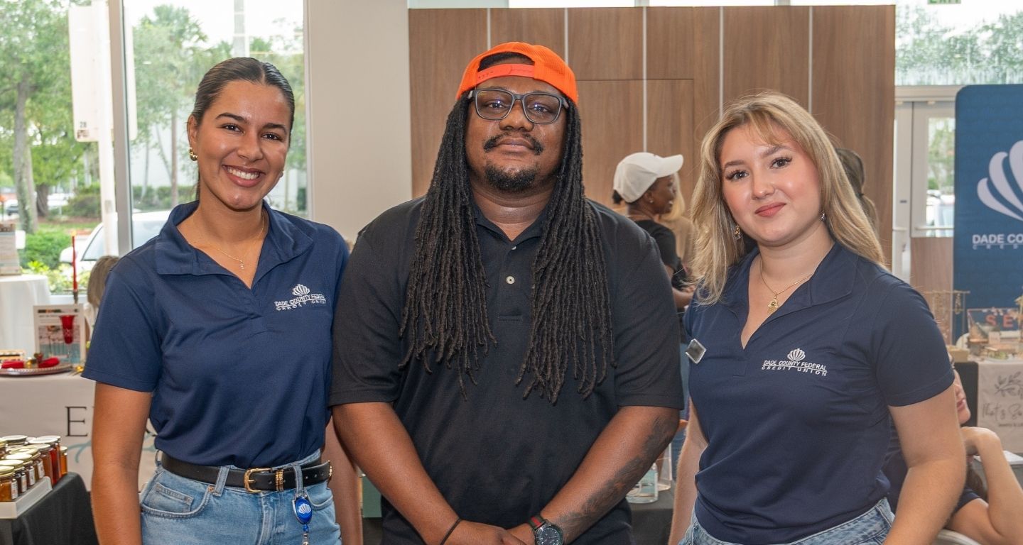 dcfcu employees with vendor at farmers market
