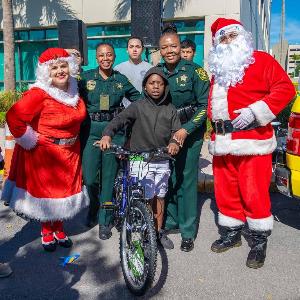 Santa and Mrs. Claus posing with officers and members