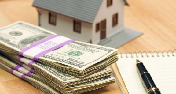 stack of cash with house
