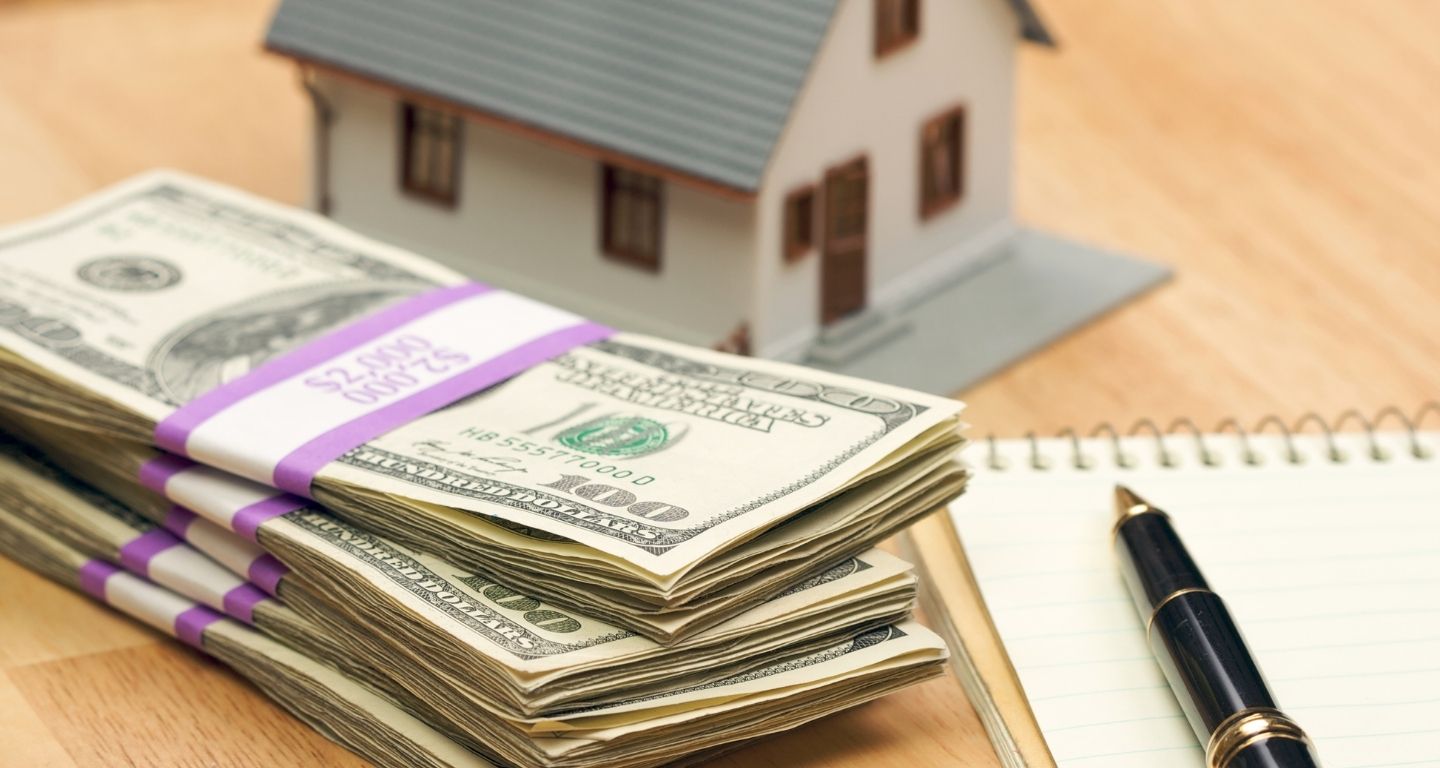 pile of cash with house