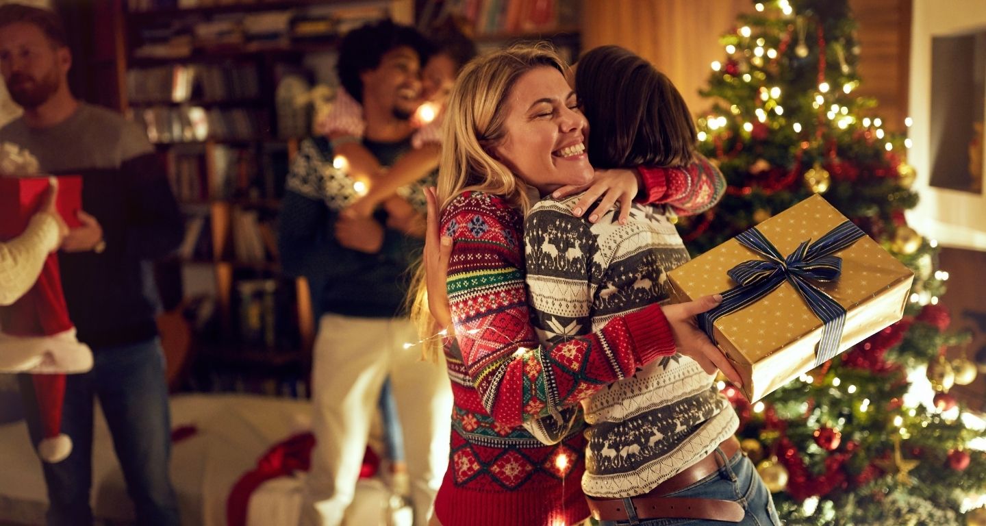 people giving holiday gifts