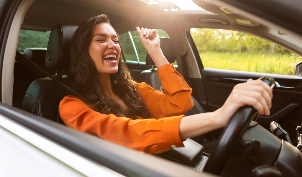 woman in car singing