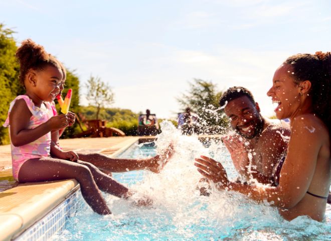 family playing in pool