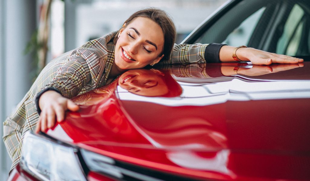 girl laying on red car